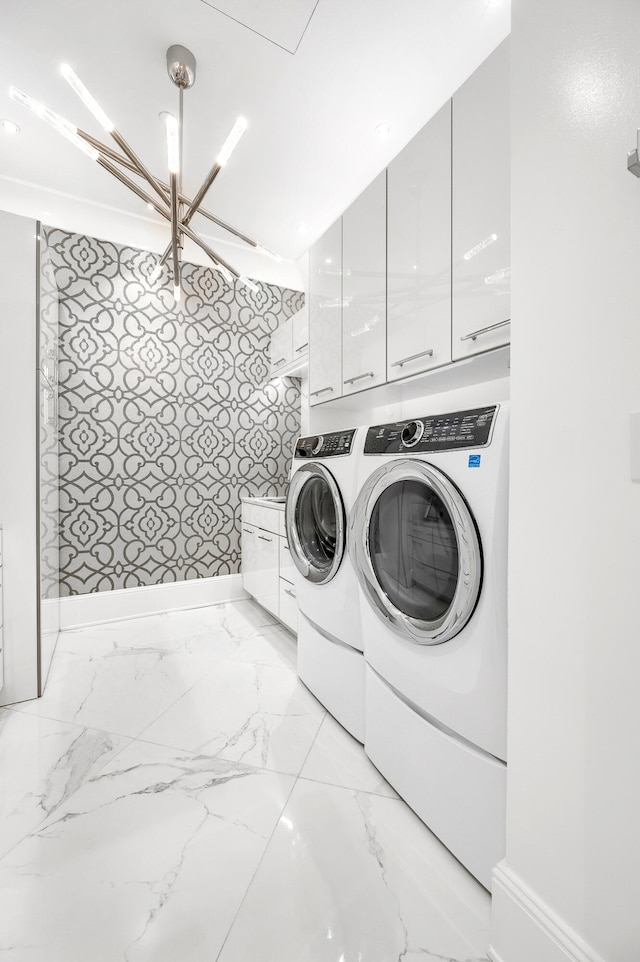 clothes washing area featuring washer and dryer, cabinets, and light tile floors