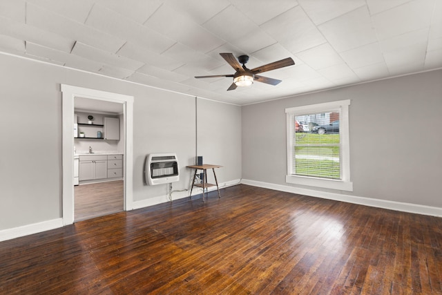 unfurnished living room with sink, ceiling fan, and wood-type flooring