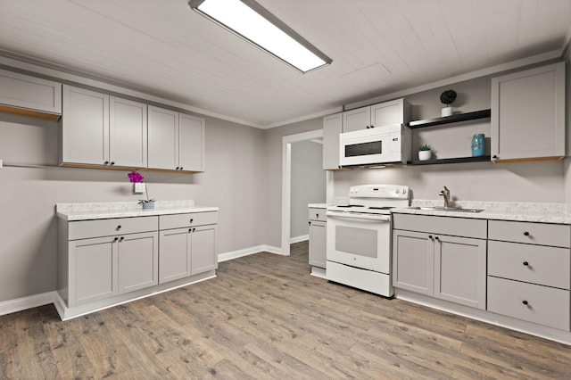 kitchen featuring light hardwood / wood-style flooring, white appliances, and gray cabinetry