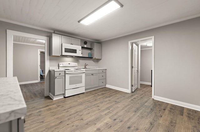 kitchen featuring hardwood / wood-style floors, gray cabinets, white appliances, and ornamental molding