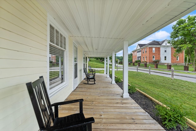 wooden deck featuring a lawn