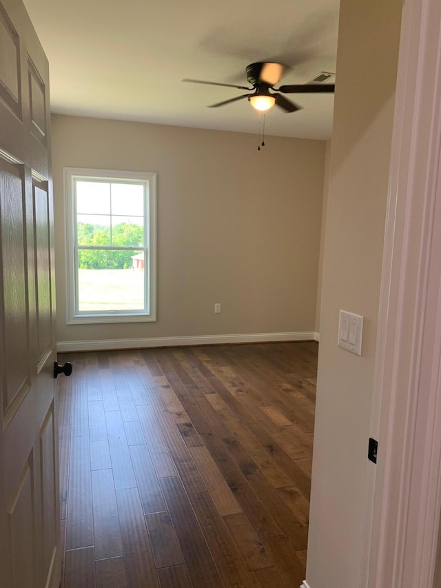 unfurnished room with ceiling fan and dark hardwood / wood-style floors