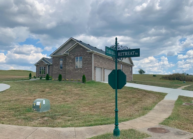 view of property exterior featuring a lawn and a garage