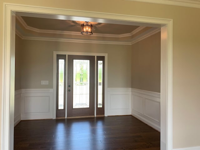 foyer featuring ornamental molding and dark hardwood / wood-style floors