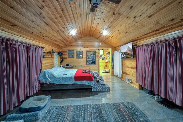 bedroom with wooden ceiling, vaulted ceiling, and wooden walls