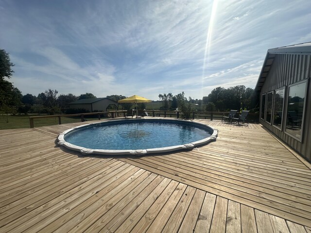 view of swimming pool featuring a deck