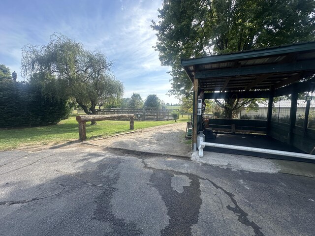 view of parking with a yard