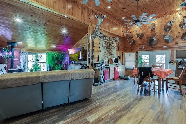 interior space featuring wood walls, wood-type flooring, french doors, wood ceiling, and ceiling fan