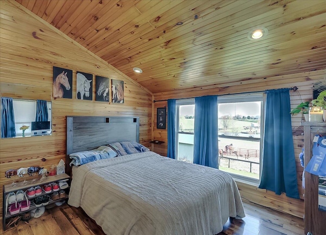 bedroom featuring lofted ceiling, wood-type flooring, wood ceiling, and wooden walls