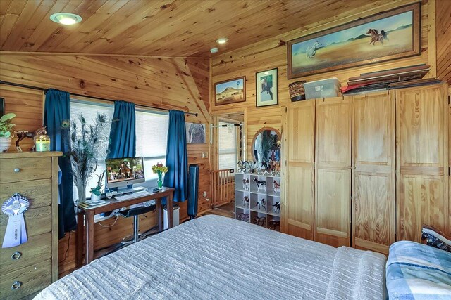 bedroom featuring wooden ceiling, lofted ceiling, hardwood / wood-style flooring, and wood walls