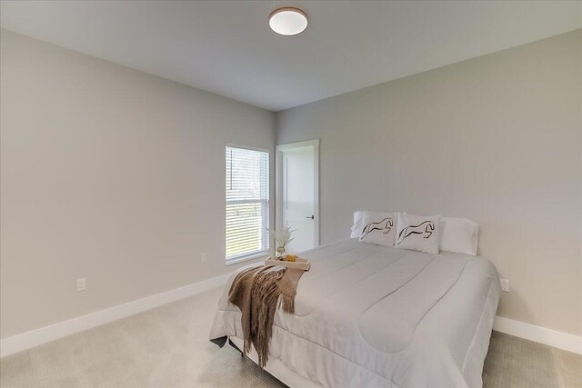 bedroom with light colored carpet