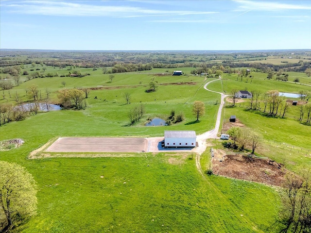 drone / aerial view featuring a rural view and a water view