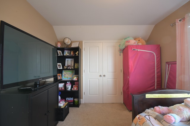 bedroom featuring lofted ceiling and light carpet