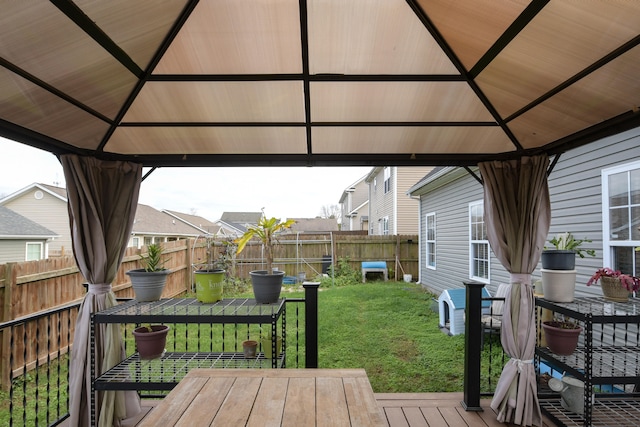 wooden deck with a gazebo and a yard