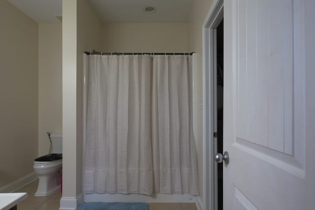 bathroom with toilet, vanity, and tile patterned floors