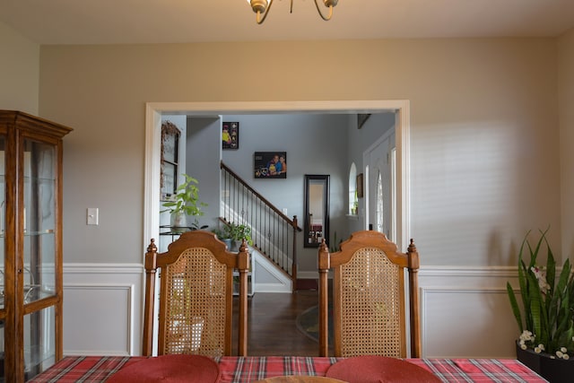 dining area with a notable chandelier and dark hardwood / wood-style flooring