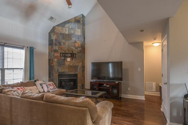 living room featuring a fireplace, dark wood-type flooring, and high vaulted ceiling