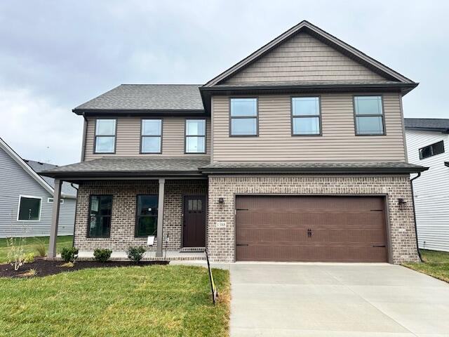 view of front of property featuring a garage and a front lawn