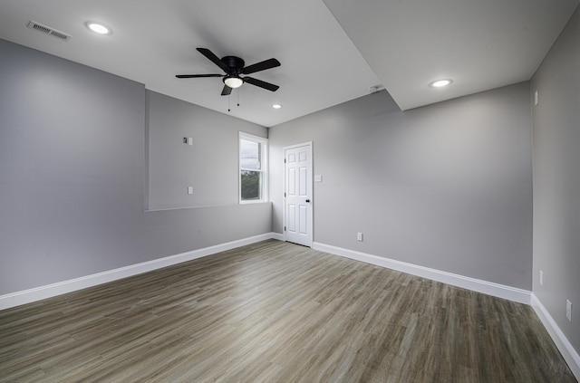 empty room featuring ceiling fan and dark wood-type flooring