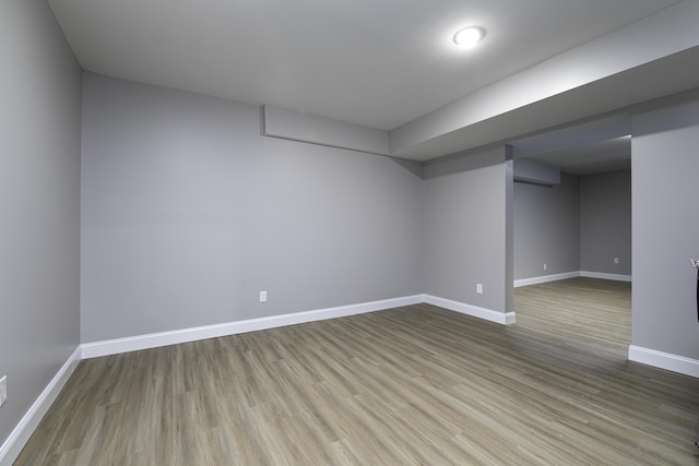 basement with hardwood / wood-style flooring