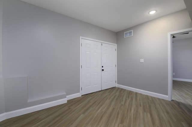 unfurnished room with hardwood / wood-style flooring