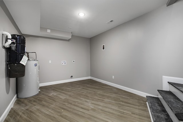 basement with wood-type flooring and water heater