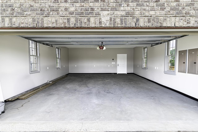 garage with electric panel and a garage door opener