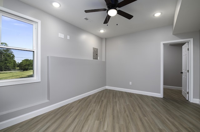 spare room featuring dark hardwood / wood-style floors, a wealth of natural light, and ceiling fan