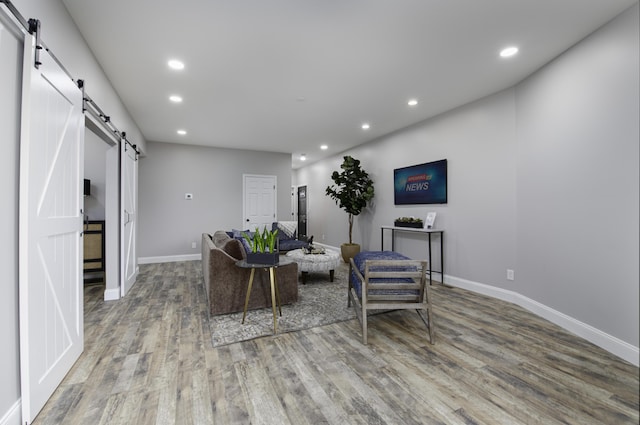 living room with hardwood / wood-style floors and a barn door