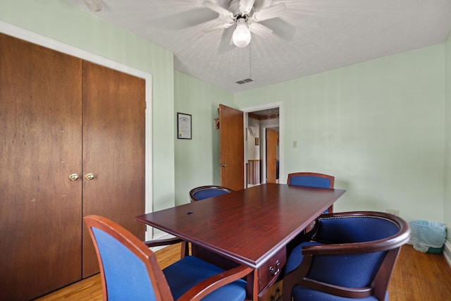 dining space with ceiling fan, visible vents, and light wood-type flooring