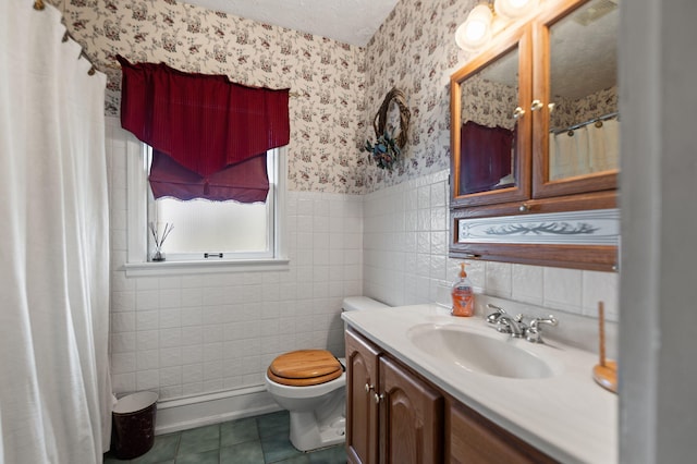 full bathroom featuring vanity, toilet, tile patterned floors, wallpapered walls, and tile walls