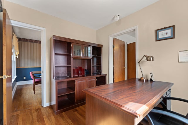 home office featuring baseboards and dark wood-style flooring