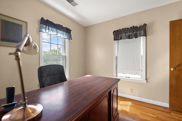 office space featuring baseboards, visible vents, and light wood-style floors
