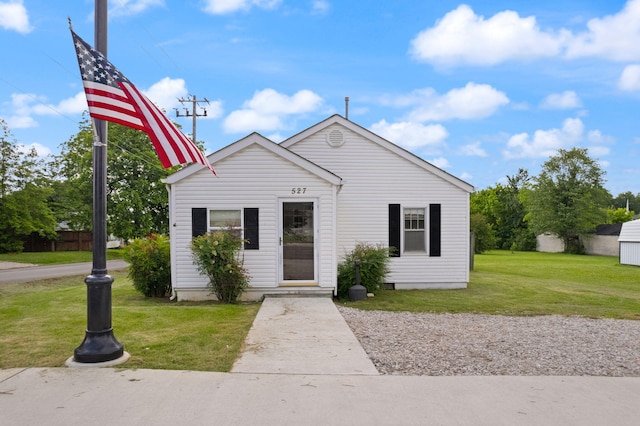 bungalow-style home with a front yard