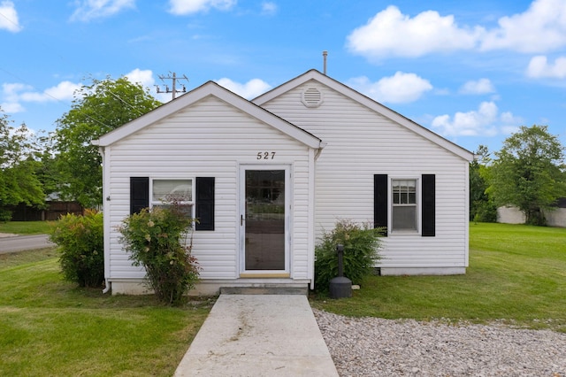 bungalow-style home with a front yard