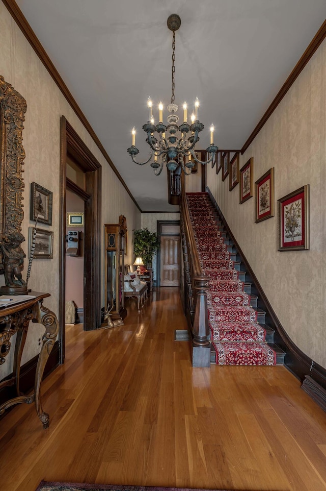 1023 Riverside Dr, Greenup, KY 41144 - foyer entrance with ornamental molding, hardwood / wood-style floors, a chandelier, and stairway