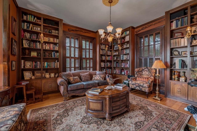 1023 Riverside Dr, Greenup, KY 41144 - living area featuring a chandelier, wood finished floors, ornamental molding, and plenty of natural light