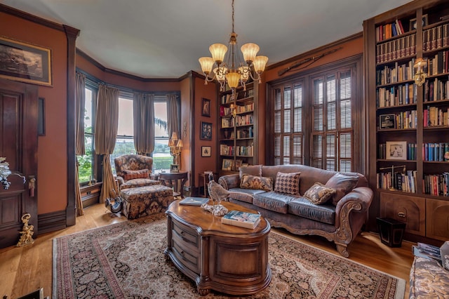 1023 Riverside Dr, Greenup, KY 41144 - living area featuring crown molding, a chandelier, wood finished floors, built in shelves, and baseboards