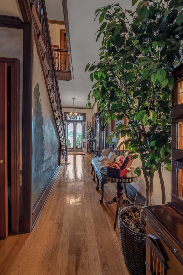 1023 Riverside Dr, Greenup, KY 41144 - hall with wood finished floors, a chandelier, french doors, and stairway