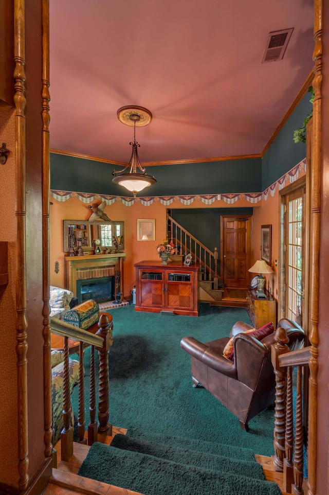 1023 Riverside Dr, Greenup, KY 41144 - carpeted living room with stairs, crown molding, and a glass covered fireplace