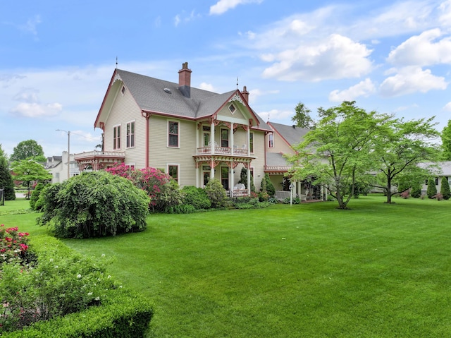 1023 Riverside Dr, Greenup, KY 41144 - rear view of house with a chimney, a yard, and a balcony