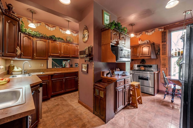 1023 Riverside Dr, Greenup, KY 41144 - kitchen with appliances with stainless steel finishes, a sink, light tile patterned floors, wood counters, and decorative light fixtures
