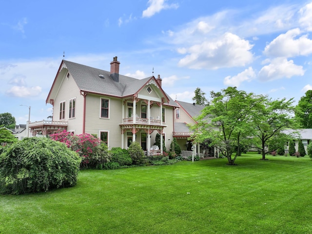 1023 Riverside Dr, Greenup, KY 41144 - rear view of house with a chimney, a lawn, and a balcony