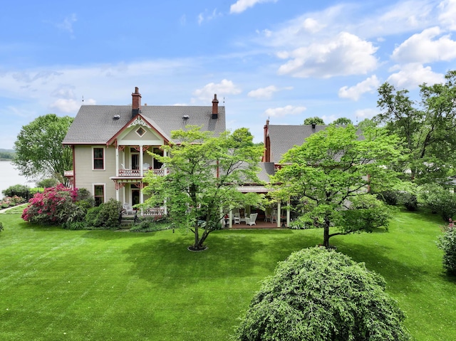 1023 Riverside Dr, Greenup, KY 41144 - rear view of property featuring a yard, a chimney, a balcony, and a water view