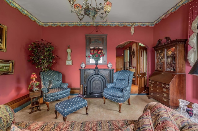 1023 Riverside Dr, Greenup, KY 41144 - living area featuring arched walkways, carpet floors, a chandelier, a wood stove, and baseboards