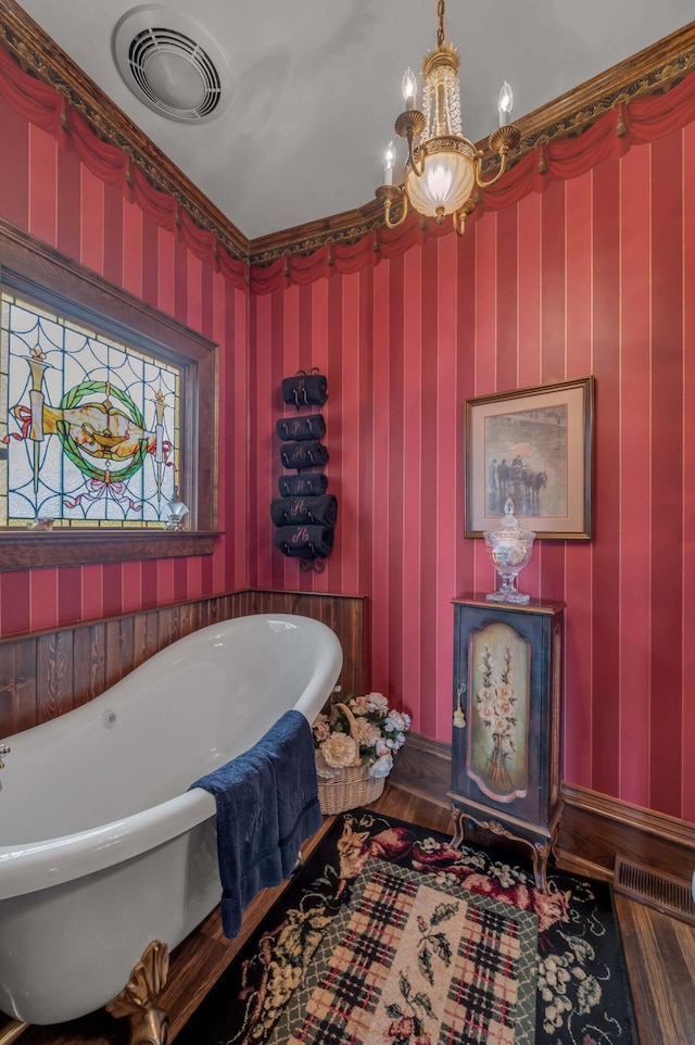 1023 Riverside Dr, Greenup, KY 41144 - bathroom with a soaking tub, a chandelier, and wood finished floors