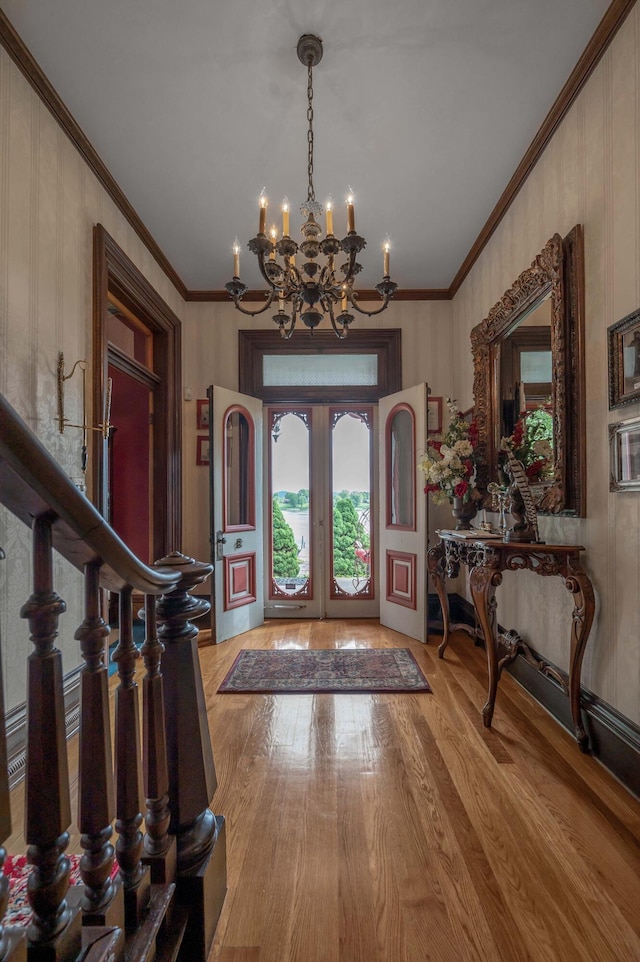 1023 Riverside Dr, Greenup, KY 41144 - entrance foyer featuring light wood finished floors, a chandelier, crown molding, and french doors