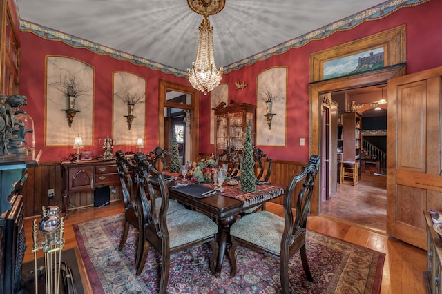 1023 Riverside Dr, Greenup, KY 41144 - dining space featuring a wainscoted wall, wood finished floors, and a chandelier