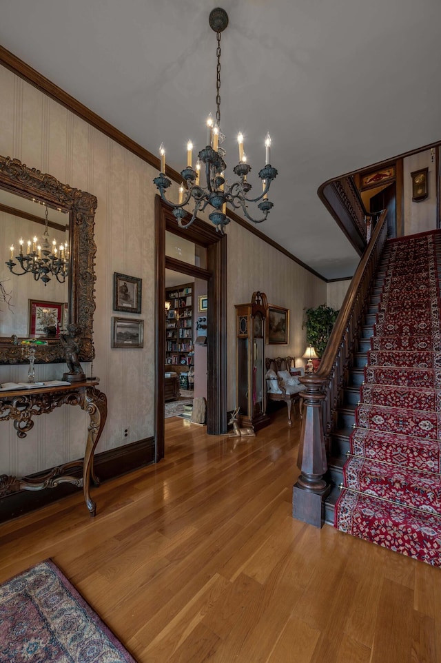 1023 Riverside Dr, Greenup, KY 41144 - stairway featuring a chandelier, crown molding, and wood finished floors