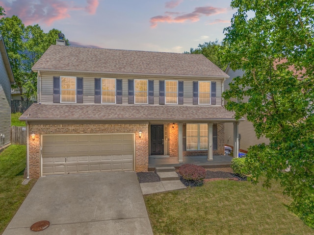 view of front of home featuring concrete driveway, brick siding, a lawn, and a chimney